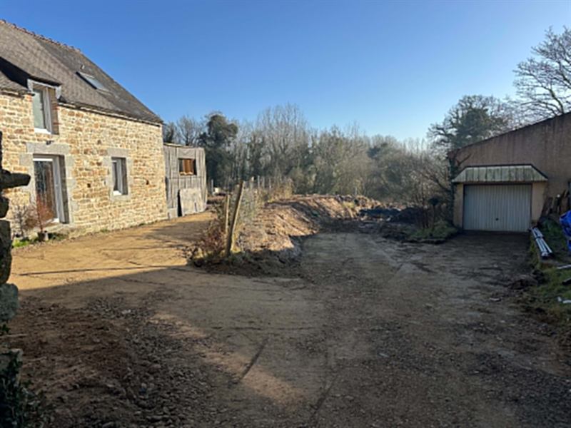Cour et accès terrassés entre une longère et un garage